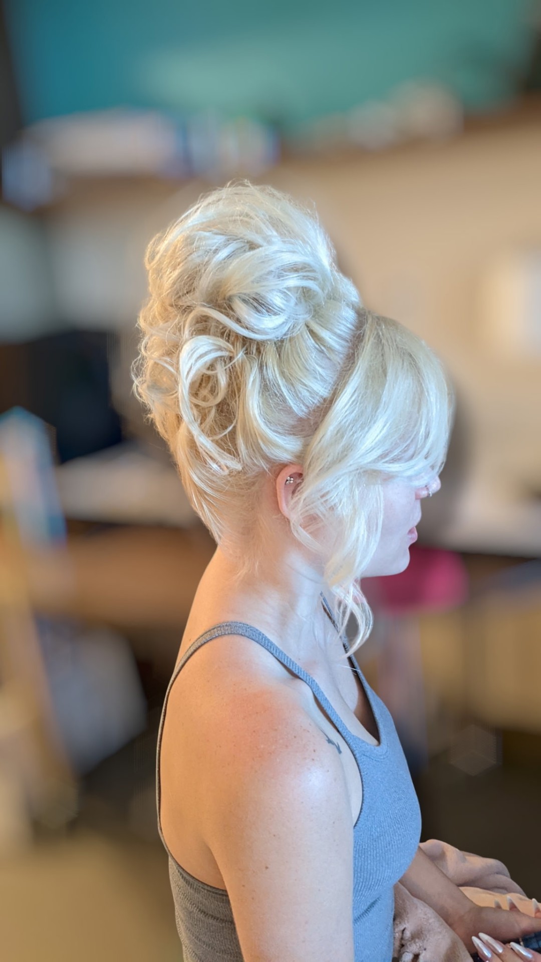 Voluminous blonde formal updo with soft face-framing curls by Hair By Sess