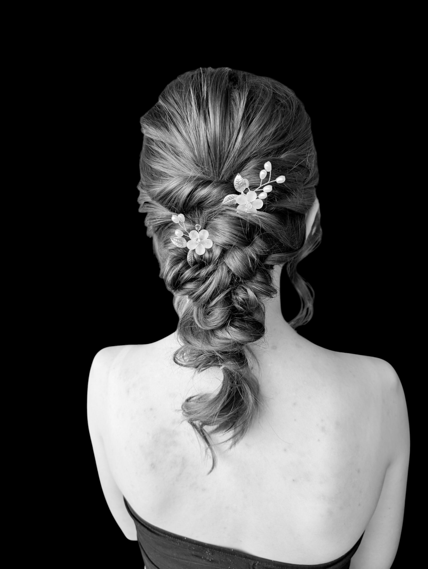 Timeless braided low updo with floral pins by Hair By Sess