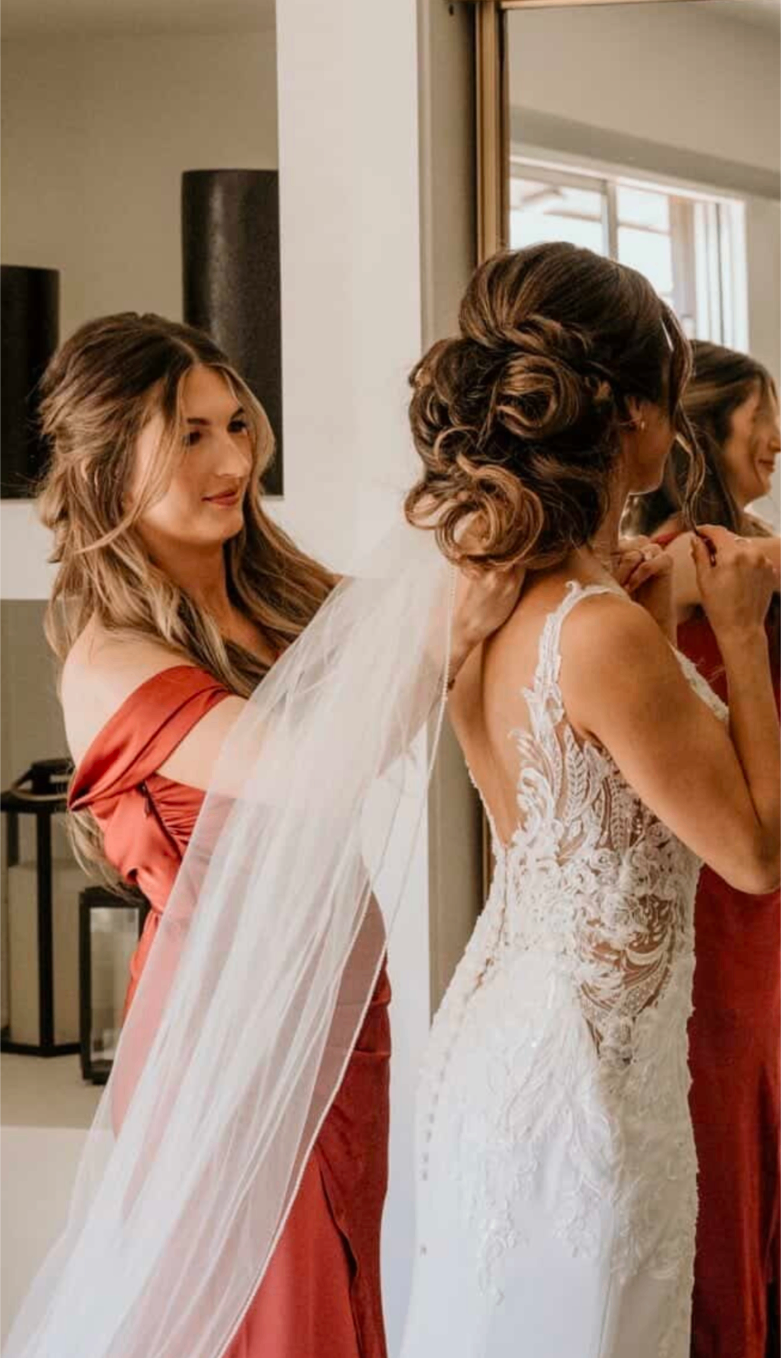 Bridal curled updo with a flowing veil on wedding morning by Hair By Sess